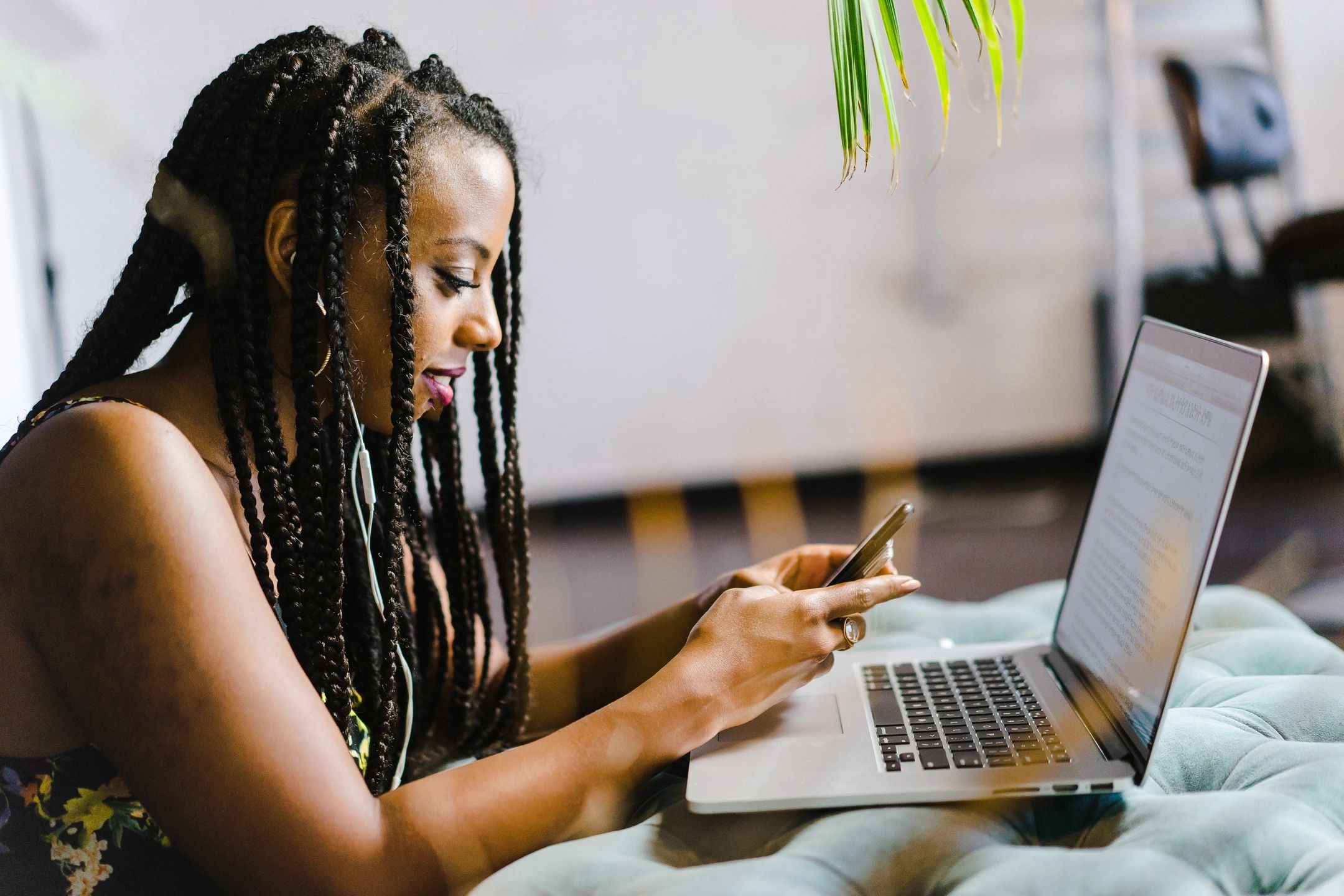 woman communicating on phone and laptop