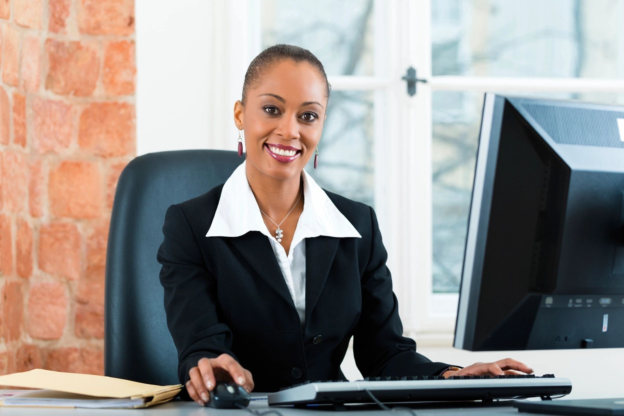 Women at desk in a suit